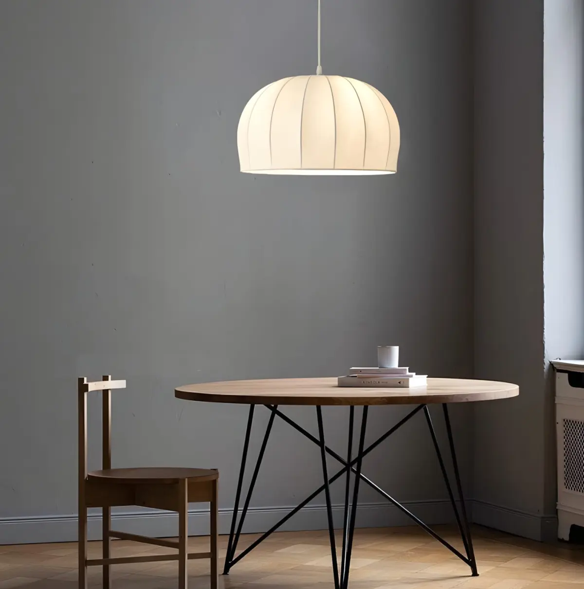 one aeron silk pendant lamp hanging above table