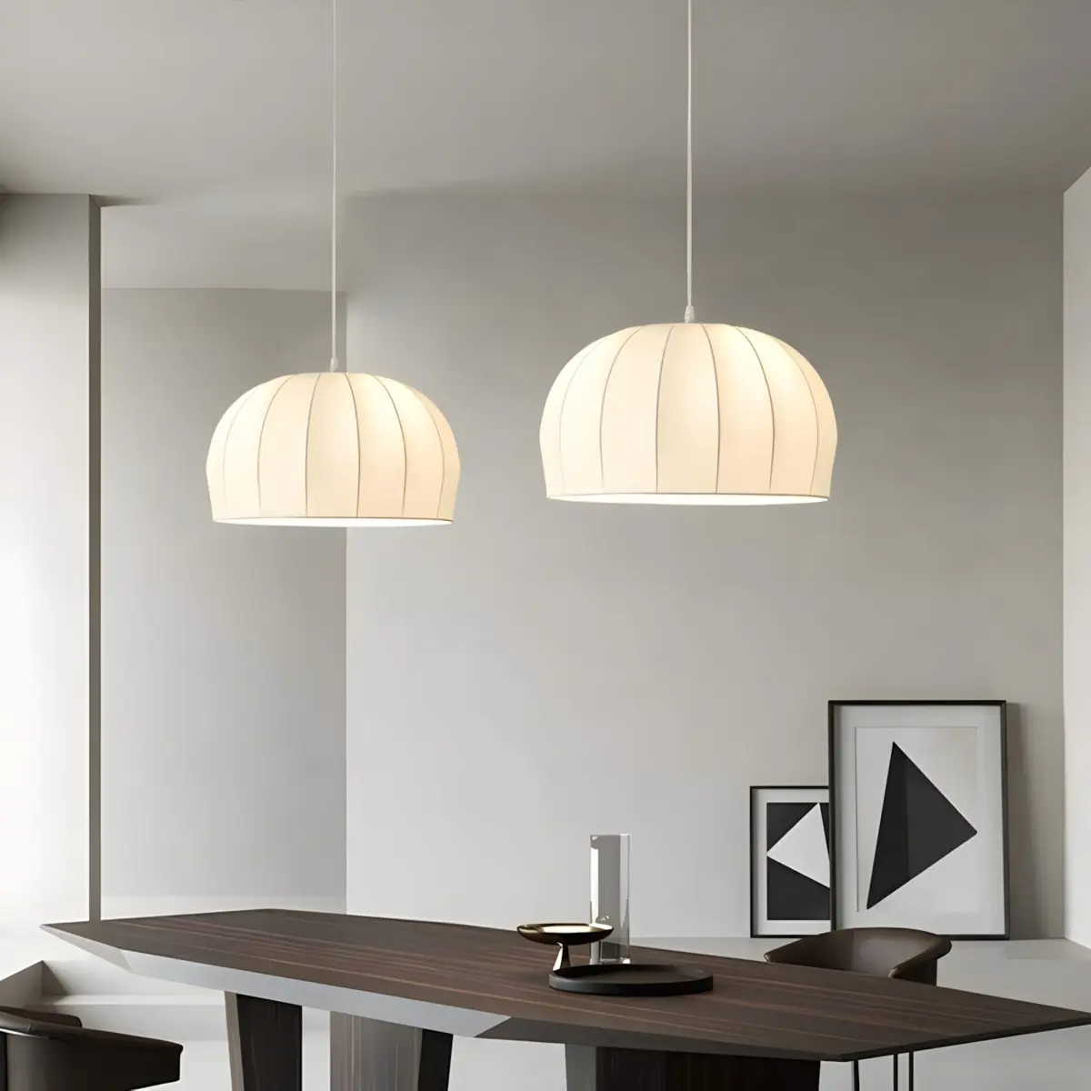 two aeron silk pendant lamp hanging above long table