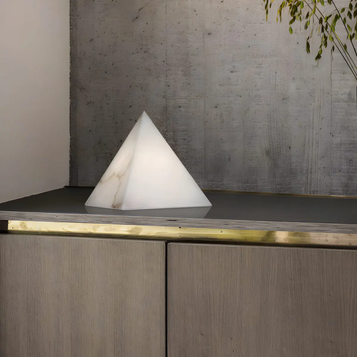 Alabaster pyramid table lamp on a cabinet