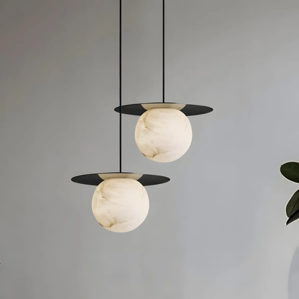 two borra moon disk pendant hanging from the ceiling