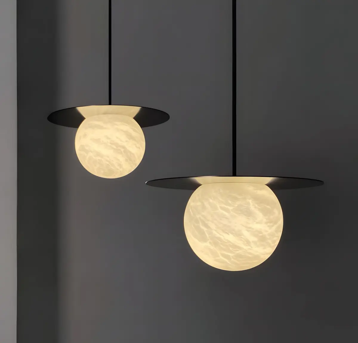 two borra moon disk pendant hanging in a dark room