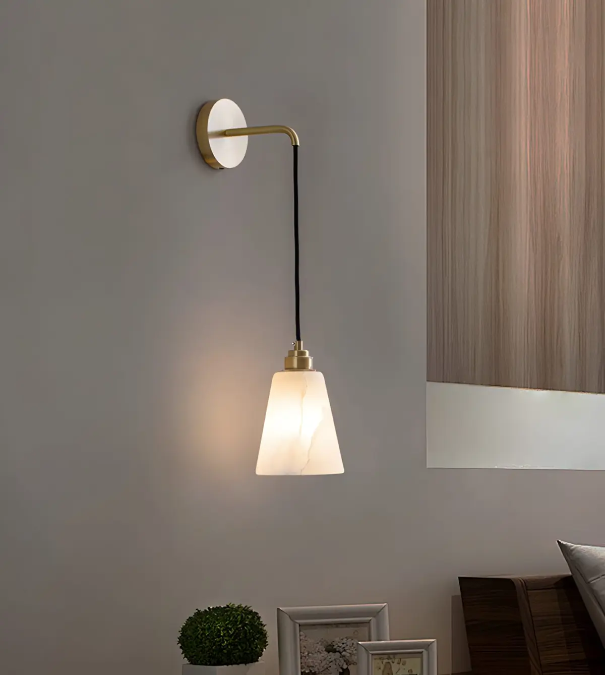 Droplet wall lamp hanging beside a bed