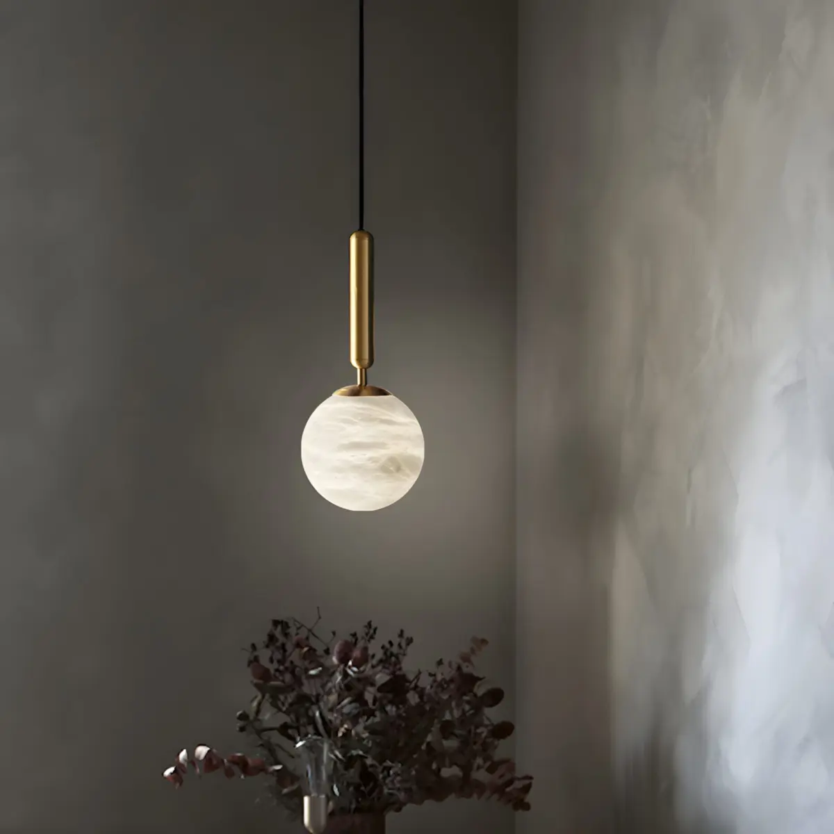 hera round pendant light hanging in the coner