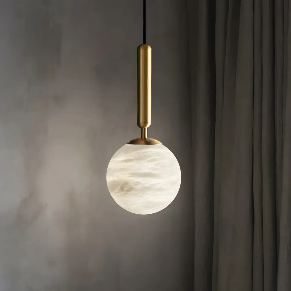hera round pendant light hanging from ceiling