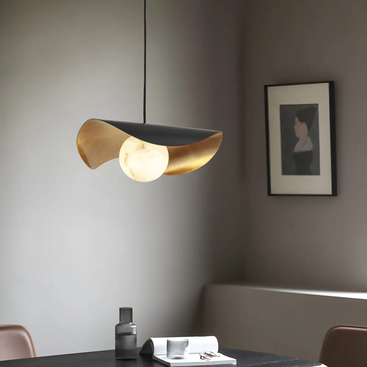 Ida lotus pendant light hanging above a table