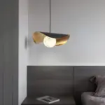 Ida lotus pendant light hanging beside a bed