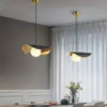 two ida lotus pendant light hanging in a dining room