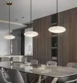 three luna cake pendant light hanging above dining table