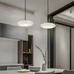 two luna cake pendant light hanging above dining table