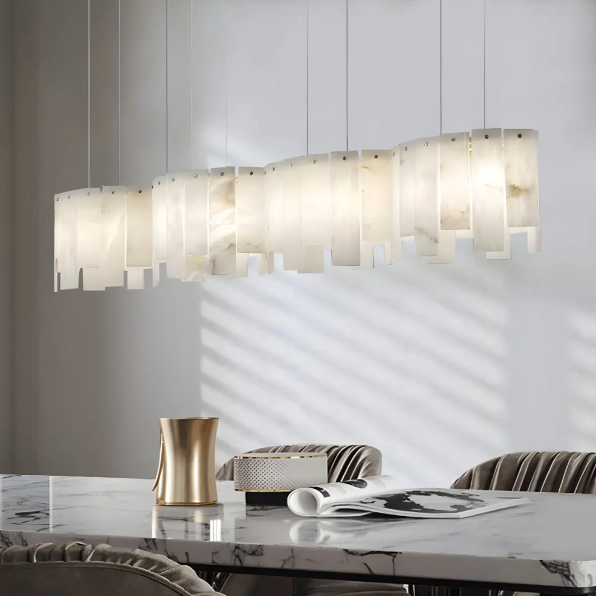 mara alabaster chandelier hanging above table