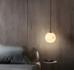 Moon ball pendant light hanging beside the bed