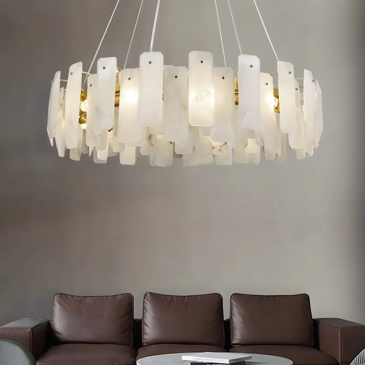 noah round chandelier hanging above leather sofa