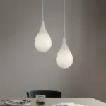 double raindrop pendant light hanging above the table
