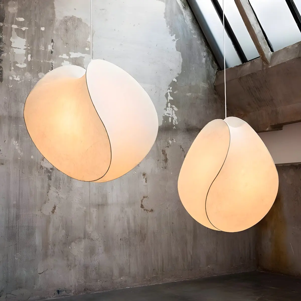 two tacchini equinox pendant light hanging from ceiling