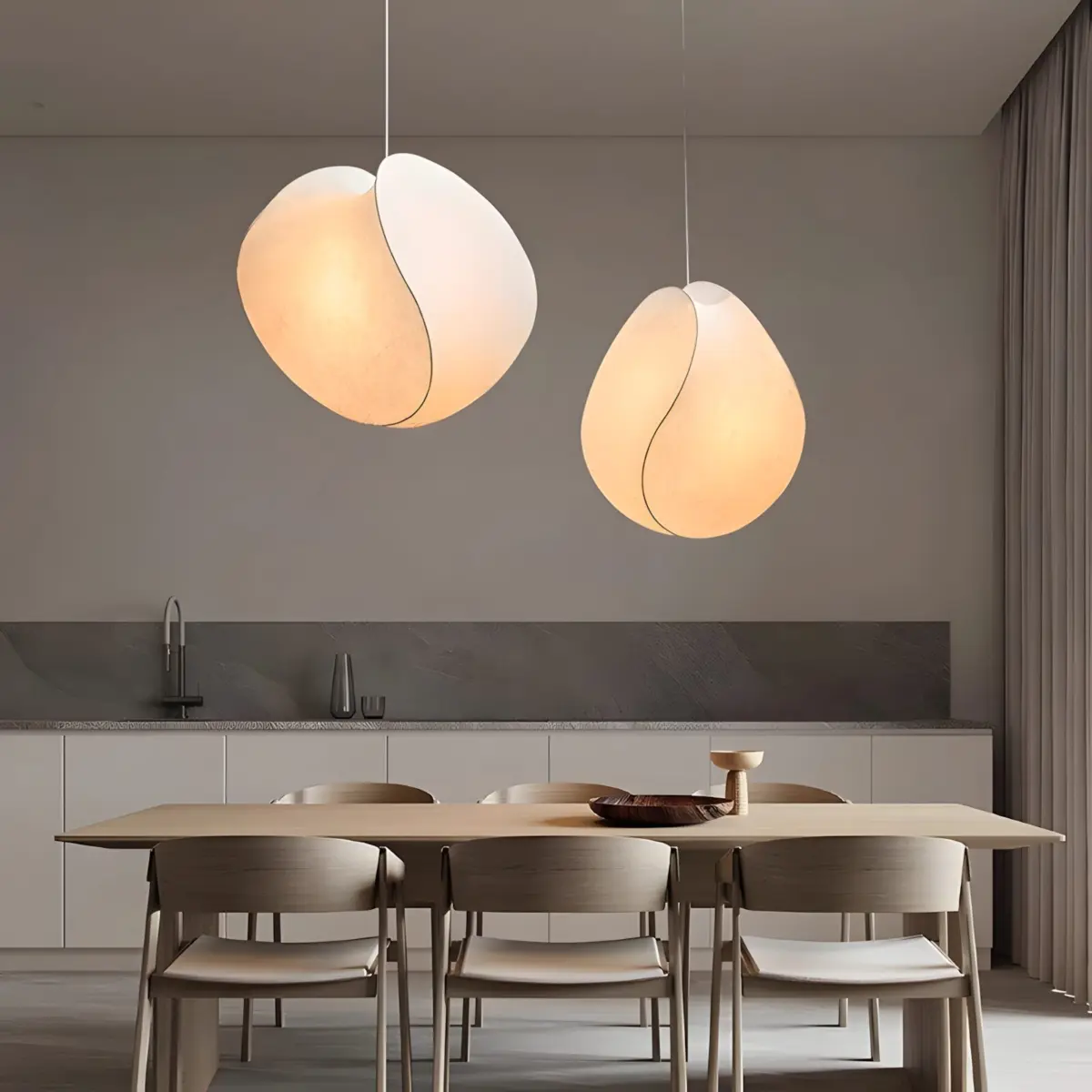 two tacchini equinox pendant light hanging in the dining room