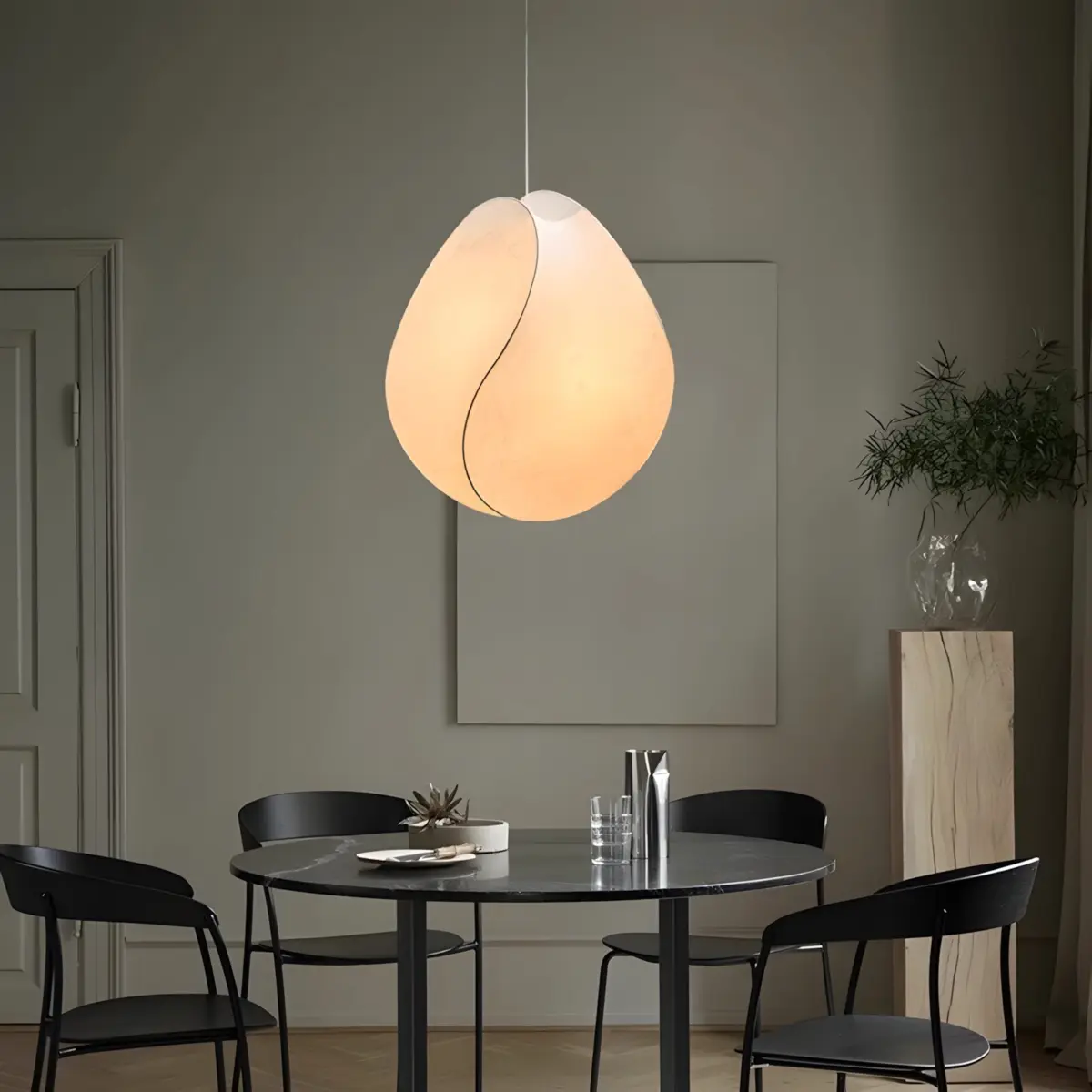 one tacchini equinox pendant light hanging above table