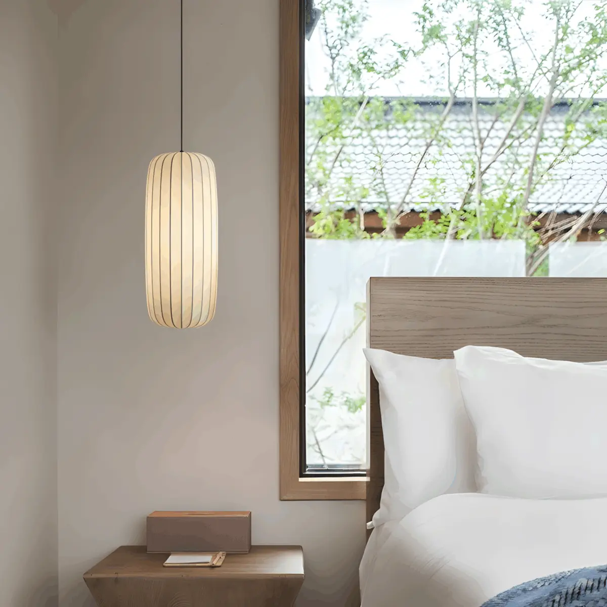 one of the arturesthome wabi-sabi pendant light hanging as bedside light