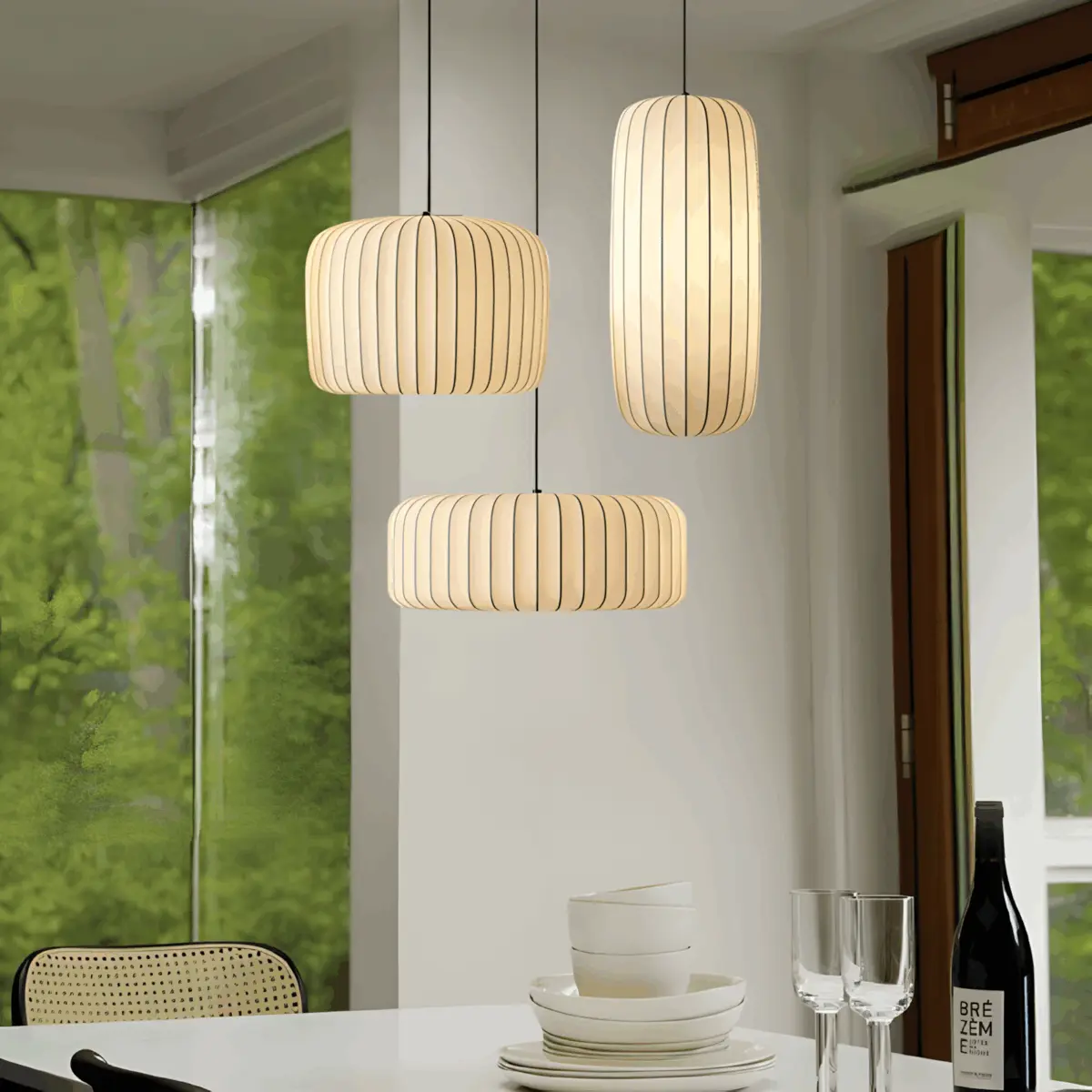 three different size arturesthome wabi-sabi pendant light hanging above dining table