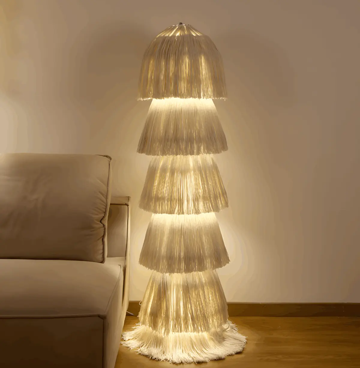lighted boho yarn floor lamp beside a sofa