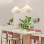 two ethereal bloom fabric pendant light hanging above dining table