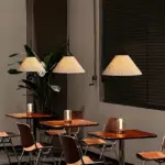 Each nebra pleated pendant lamp is hung on each table in the restaurant