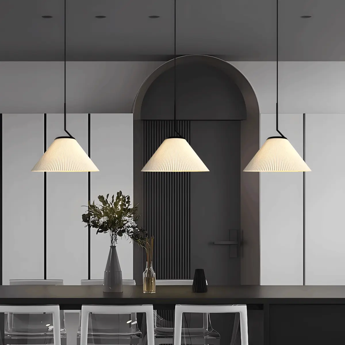 three nebra pleated pendant lamp is hung on dining table