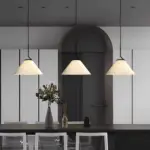 three nebra pleated pendant lamp is hung on dining table
