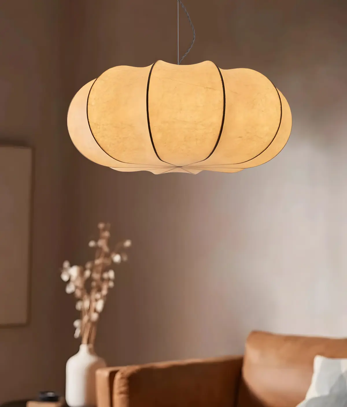 oblate pumpkin shade silk made pendant lamp hanging in a room