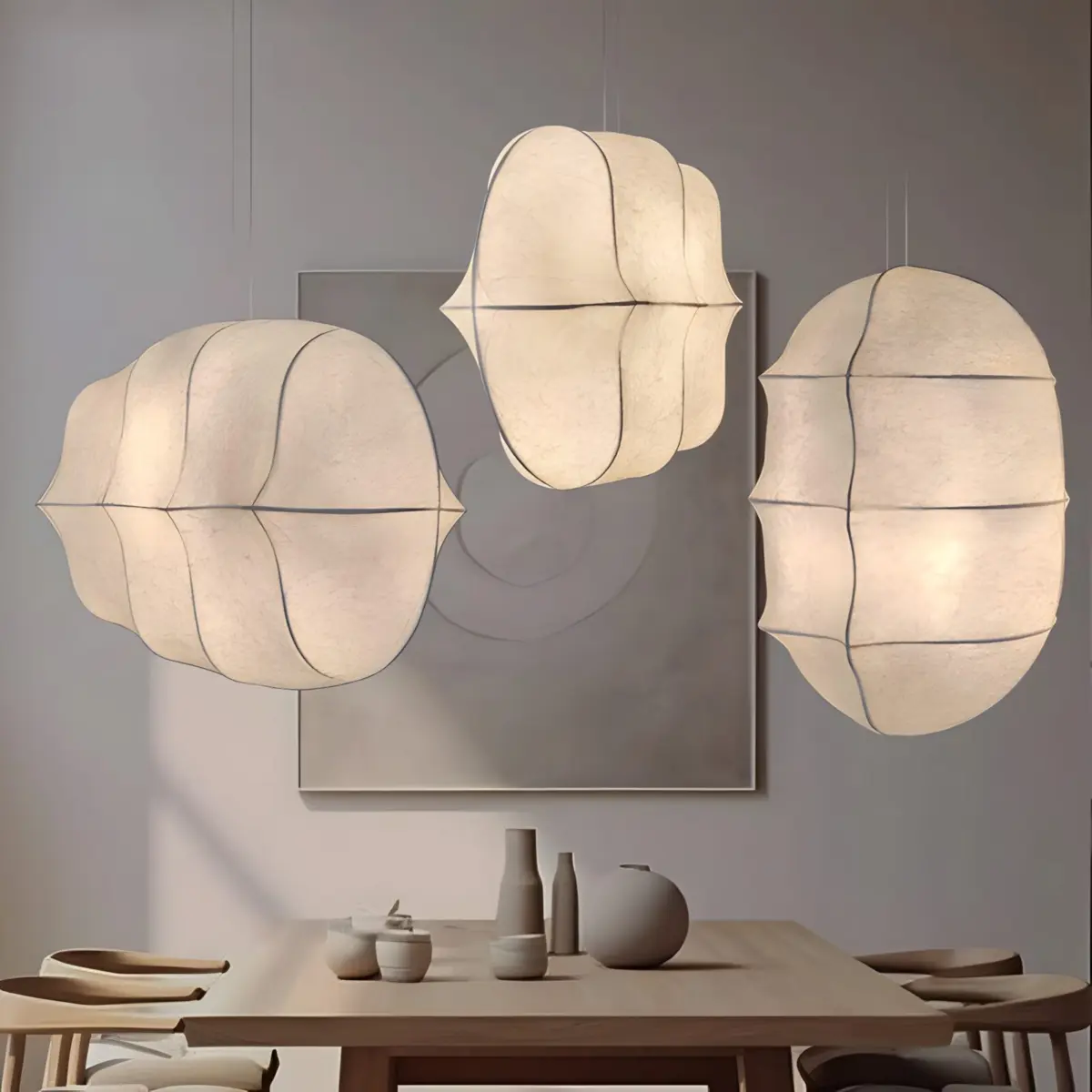 three different size studiopepe tacchini gunta pendant light hanging above table