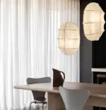 two different size studiopepe tacchini gunta pendant light hanging above table