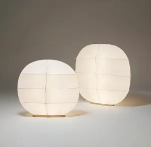 two size of tacchini gunta floor lamp lighted on the floor