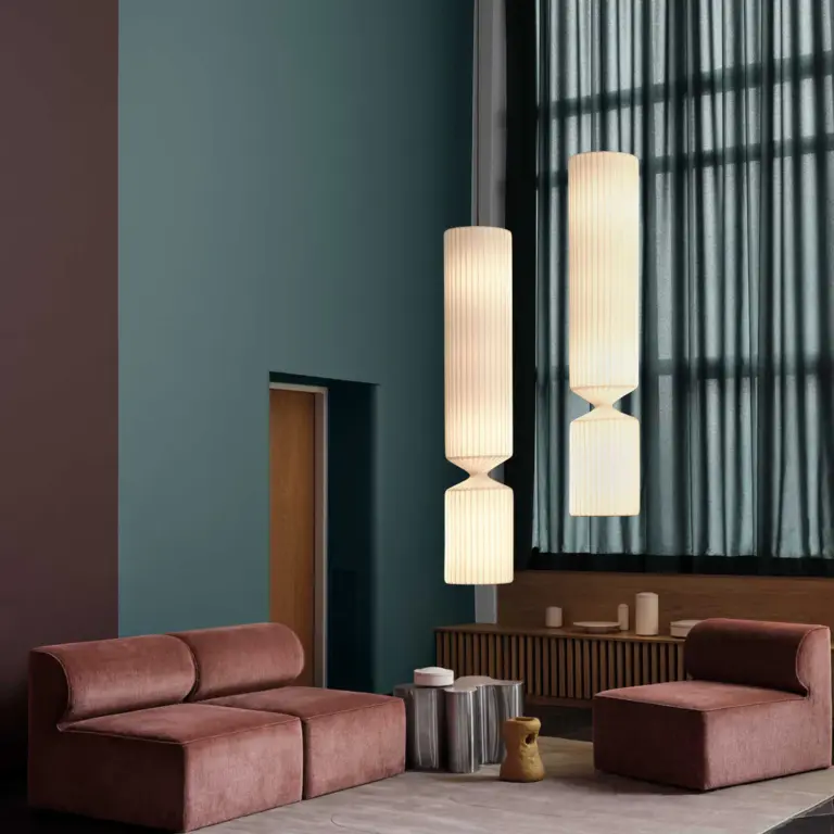 two lighted tom rossau tr41 pendant light hanging in living room