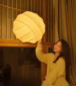 warm light turner silk made pendant lamp hanging in a room